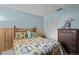 Cozy blue bedroom with light wood accents and bright natural light at 7535 Greystone Dr, Hudson, FL 34667