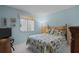Comfortable bedroom with light blue walls, wood accents, and cozy decor at 7535 Greystone Dr, Hudson, FL 34667