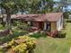 Charming home with well-maintained landscaping, a welcoming front porch, and two rocking chairs at 7535 Greystone Dr, Hudson, FL 34667