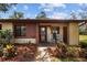 Charming home with well-kept landscaping, a cozy front porch and rocking chairs at 7535 Greystone Dr, Hudson, FL 34667