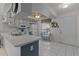 Eat-in kitchen featuring ample counter space, white appliances and white tile flooring at 7535 Greystone Dr, Hudson, FL 34667