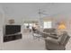 Well-lit living room featuring neutral carpet, comfortable seating area and large windows at 7535 Greystone Dr, Hudson, FL 34667