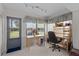 Bright office space featuring natural light, neutral carpet and a door leading to the outside at 7535 Greystone Dr, Hudson, FL 34667