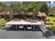 Exterior shot of parking area covered by large trees at 7535 Greystone Dr, Hudson, FL 34667