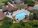 Aerial view of a sparkling community pool with surrounding lounge chairs and mature trees at 7535 Greystone Dr, Hudson, FL 34667