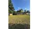 A view of a large backyard with a chainlink fence and trees at 7620 32Nd S Ave, Tampa, FL 33619