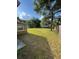 Expansive backyard with lush green grass and mature trees, perfect for outdoor activities and relaxation at 7620 32Nd S Ave, Tampa, FL 33619