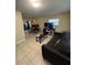 Comfortable living room with tile floors, a large sofa, and plenty of space for entertaining guests at 7620 32Nd S Ave, Tampa, FL 33619
