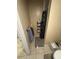 Small bathroom view with a dark shower curtain, a rack full of toiletries, and a grey towel hanging at 7620 32Nd S Ave, Tampa, FL 33619