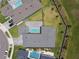 Aerial view showcases a house with a pool, well-maintained yard, and privacy fencing at 8421 Ivy Stark Blvd, Wesley Chapel, FL 33545