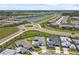 Aerial view of a residential community featuring modern homes, lakes, and well-maintained landscaping at 8421 Ivy Stark Blvd, Wesley Chapel, FL 33545