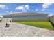 Spacious backyard featuring a paver patio, lush green lawn, and privacy fence at 8421 Ivy Stark Blvd, Wesley Chapel, FL 33545
