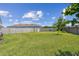 Over-sized backyard with lush green lawn and a privacy fence at 8421 Ivy Stark Blvd, Wesley Chapel, FL 33545
