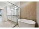 Modern bathroom featuring a soaking tub, walk-in glass shower, and double vanity at 8421 Ivy Stark Blvd, Wesley Chapel, FL 33545