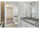 Bathroom with granite counter tops, toilet, and a view to the bedroom at 8421 Ivy Stark Blvd, Wesley Chapel, FL 33545