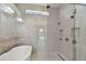Modern bathroom boasts a frameless shower and freestanding soaking tub at 8421 Ivy Stark Blvd, Wesley Chapel, FL 33545