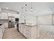 Bright kitchen features stainless steel appliances, a large island, and white cabinets at 8421 Ivy Stark Blvd, Wesley Chapel, FL 33545