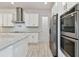 Bright kitchen with granite counters, stainless appliances and white cabinets at 8421 Ivy Stark Blvd, Wesley Chapel, FL 33545