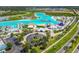 Aerial view of a lagoon featuring a bar, beach areas, recreational activities, and palm trees at 8421 Ivy Stark Blvd, Wesley Chapel, FL 33545