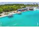 An aerial view of the lagoon with lounge seating and cabanas along the edge of the beautiful blue water at 8421 Ivy Stark Blvd, Wesley Chapel, FL 33545