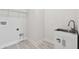 Laundry room features a sink and storage, complete with washer/dryer hookups at 8421 Ivy Stark Blvd, Wesley Chapel, FL 33545