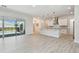 Bright open-concept design with view into modern kitchen at 8421 Ivy Stark Blvd, Wesley Chapel, FL 33545