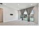 Bright living room features sliding glass doors leading to the pool at 8421 Ivy Stark Blvd, Wesley Chapel, FL 33545