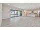 Spacious living room with sliding glass doors to outdoor pool area at 8421 Ivy Stark Blvd, Wesley Chapel, FL 33545