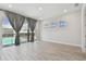 Bright living room features sliding glass doors leading to the pool area at 8421 Ivy Stark Blvd, Wesley Chapel, FL 33545