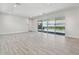 Bright living room with large sliding doors viewing the pool area at 8421 Ivy Stark Blvd, Wesley Chapel, FL 33545