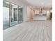 Open-concept living area with access to a covered outdoor space at 8421 Ivy Stark Blvd, Wesley Chapel, FL 33545