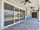 Covered patio with ceiling fans and view of fenced pool and backyard at 8421 Ivy Stark Blvd, Wesley Chapel, FL 33545
