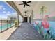 View of the lanai featuring a painted mural, ceiling fans, pavers and a pool at 8421 Ivy Stark Blvd, Wesley Chapel, FL 33545