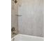 Close up of tiled shower featuring glass shelf and modern fixture at 8421 Ivy Stark Blvd, Wesley Chapel, FL 33545