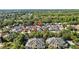 An aerial view of a residential neighborhood showcasing single-Gathering homes and apartment buildings nestled among lush greenery at 8820 Cypress Hammock Dr, Tampa, FL 33614
