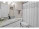 Bright bathroom with granite countertops, white cabinets and decorative shower curtain at 8820 Cypress Hammock Dr, Tampa, FL 33614