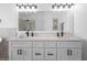 Bright bathroom features double vanity with modern faucets, granite countertops, and large mirror, plus a glass shower at 8820 Cypress Hammock Dr, Tampa, FL 33614