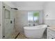 Bathroom showcasing a glass shower, freestanding tub, and granite topped vanity with modern fixtures at 8820 Cypress Hammock Dr, Tampa, FL 33614
