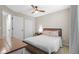 Cozy bedroom featuring a ceiling fan, a wooden bed frame and neutral color scheme at 8820 Cypress Hammock Dr, Tampa, FL 33614