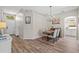 Cozy dining area featuring modern decor, wood-look flooring, and a stylish chandelier at 8820 Cypress Hammock Dr, Tampa, FL 33614