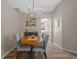 Elegant dining area showcasing wood-look flooring, stylish lighting, and a peek into the kitchen at 8820 Cypress Hammock Dr, Tampa, FL 33614
