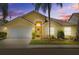 Charming single-Gathering home featuring a two-car garage, well-manicured lawn, and attractive curb appeal at 8820 Cypress Hammock Dr, Tampa, FL 33614