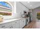 Bright kitchen boasts granite countertops, white cabinetry, and stainless steel appliances with natural light from large window at 8820 Cypress Hammock Dr, Tampa, FL 33614