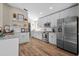 Spacious kitchen with stainless steel appliances, granite countertops, and white cabinetry offers modern appeal at 8820 Cypress Hammock Dr, Tampa, FL 33614