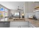 Modern kitchen featuring light-colored cabinets, a spacious sink, and views into the living room at 8820 Cypress Hammock Dr, Tampa, FL 33614