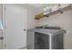 Modern laundry room with front loading washer and dryer and storage shelves at 8820 Cypress Hammock Dr, Tampa, FL 33614