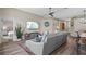 Spacious living room featuring comfortable seating, wood-look floors, and a view into the bedroom at 8820 Cypress Hammock Dr, Tampa, FL 33614