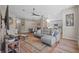 Open-concept living area with a comfortable gray sofa, wood-look flooring, and lots of natural light at 8820 Cypress Hammock Dr, Tampa, FL 33614