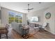 Inviting living room with wood-look flooring, a comfortable sofa, and large windows for plenty of light at 8820 Cypress Hammock Dr, Tampa, FL 33614