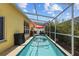 A luxurious swimming pool is enclosed with a screened lanai and has patio furniture at 8820 Cypress Hammock Dr, Tampa, FL 33614